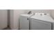 Modern laundry room showcasing side-by-side Samsung washer and dryer at 1167 Celery Oaks Ln, Sanford, FL 32771