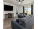 Bright living room with a large window, comfortable seating, and modern media console, perfect for relaxation at 1167 Celery Oaks Ln, Sanford, FL 32771