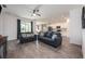 Cozy living room with contemporary furnishings, hardwood floors, and a view of the open-concept kitchen and dining area at 1167 Celery Oaks Ln, Sanford, FL 32771