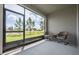 Screened porch with seating and a view of a pond and green grass at 1167 Celery Oaks Ln, Sanford, FL 32771