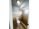 Bathroom with a toilet, tiled shower, and small window at 12112 Shallot St, Orlando, FL 32837