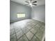 Bedroom with tile floors, a ceiling fan, and window, offers a comfortable and simple space at 12112 Shallot St, Orlando, FL 32837