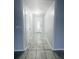The long hallway has grey ceramic tile at 12112 Shallot St, Orlando, FL 32837