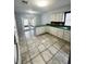 Kitchen features ceramic tile, ample counter space, and white cabinetry at 12112 Shallot St, Orlando, FL 32837