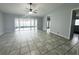 A bright living room features ceramic tile, a ceiling fan, and sliding glass doors at 12112 Shallot St, Orlando, FL 32837