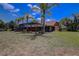 Sprawling backyard with lush grass and a view of the screened-in pool at 12202 Rambling Oak Blvd, Orlando, FL 32832