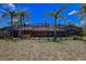 View of the home's backyard, screened-in pool, and patio area at 12202 Rambling Oak Blvd, Orlando, FL 32832