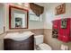 Bathroom with vanity, toilet, and a decorative mirror and towel set at 12202 Rambling Oak Blvd, Orlando, FL 32832
