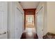 Hallway view leading to a sunken tub with decorative curtains and a large window at 12202 Rambling Oak Blvd, Orlando, FL 32832
