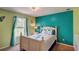 Bright bedroom with a bed, large window, and colorful, light green and turquoise walls at 12202 Rambling Oak Blvd, Orlando, FL 32832