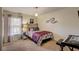 Cozy bedroom with a window, carpeted floors, and stylish musical note decor above the bed at 12202 Rambling Oak Blvd, Orlando, FL 32832