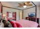 Comfortable bedroom with a four-poster bed, ceiling fan, and mirrored closet doors at 12202 Rambling Oak Blvd, Orlando, FL 32832
