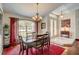 Elegant dining room featuring wood floors, large windows, and stylish chandelier at 12202 Rambling Oak Blvd, Orlando, FL 32832