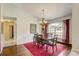 Dining room with hardwood floors, chandelier, and large window at 12202 Rambling Oak Blvd, Orlando, FL 32832