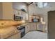 Bright kitchen with granite countertops, stainless steel appliances, and updated finishes at 12202 Rambling Oak Blvd, Orlando, FL 32832