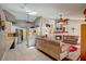Spacious living room with fireplace, open kitchen, skylights, and neutral color palette at 12202 Rambling Oak Blvd, Orlando, FL 32832