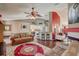 Inviting living room features a ceiling fan, an open kitchen with counter seating, and a fireplace at 12202 Rambling Oak Blvd, Orlando, FL 32832