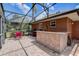 Screened in patio area featuring an outdoor kitchen and tiled floors at 12202 Rambling Oak Blvd, Orlando, FL 32832