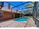 Screened in pool and spa area showcasing the rear exterior of the home at 12202 Rambling Oak Blvd, Orlando, FL 32832