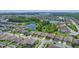 Aerial view of a neighborhood with a lake, lush greenery, and well-maintained homes at 12289 Prairie Plantation Way, Orlando, FL 32824