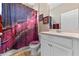 Stylish bathroom with a vibrant shower curtain, modern vanity, and elegant decor at 12289 Prairie Plantation Way, Orlando, FL 32824