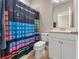 Bathroom with a periodic table themed shower curtain, white cabinets, and coordinated decor at 12289 Prairie Plantation Way, Orlando, FL 32824