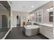 Bright bathroom features a soaking tub, dual sinks, and a glass shower with dark tile surround at 12289 Prairie Plantation Way, Orlando, FL 32824