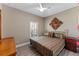 Comfortable bedroom featuring a decorative headboard, stylish bedding, and a bright window at 12289 Prairie Plantation Way, Orlando, FL 32824