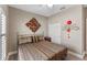 Comfortable bedroom featuring a decorative headboard, stylish bedding, and a bright window at 12289 Prairie Plantation Way, Orlando, FL 32824