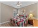 Inviting bedroom with a colorful quilt, wood floors, a bright window, and soft lighting at 12289 Prairie Plantation Way, Orlando, FL 32824