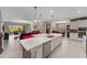 Spacious kitchen with large island, white cabinets, modern appliances, and open layout, ideal for cooking and entertaining at 12289 Prairie Plantation Way, Orlando, FL 32824