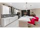 Well-appointed kitchen with stone backsplash, stainless steel appliances, and a large center island with bar seating at 12289 Prairie Plantation Way, Orlando, FL 32824