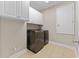 A bright laundry room featuring modern washer and dryer units and ample cabinet space at 12289 Prairie Plantation Way, Orlando, FL 32824