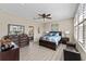 Spacious main bedroom suite with wood floors, decorative mirror, and comfortable bed with dresser at 12289 Prairie Plantation Way, Orlando, FL 32824