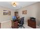 Well-lit home office with wood desk, decorative art, and elegant furniture showcasing a functional workspace at 12289 Prairie Plantation Way, Orlando, FL 32824