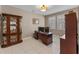 Functional office with a wooden desk, multiple computer monitors, ample storage, and shuttered windows for natural light at 12289 Prairie Plantation Way, Orlando, FL 32824
