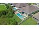 Aerial view of a home with a private pool, spa, patio, and fenced-in backyard at 12289 Prairie Plantation Way, Orlando, FL 32824
