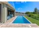 Relaxing pool with blue water and an extended patio area; lush landscape at 12289 Prairie Plantation Way, Orlando, FL 32824