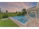 Tranquil pool area including hot tub and covered patio area for relaxing and entertaining guests at 12289 Prairie Plantation Way, Orlando, FL 32824
