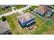 Aerial view of the backyard and two-story home with a covered patio and large lot at 1233 Nelson Park Court, Poinciana, FL 34759
