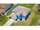 Aerial view of a two-story home with a gabled roof and a driveway at 1233 Nelson Park Court, Poinciana, FL 34759