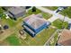 Aerial view of backyard and two-story home with a covered patio and spacious yard at 1233 Nelson Park Court, Poinciana, FL 34759