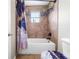 Bathroom featuring a shower-tub combo with decorative tile and updated fixtures at 1233 Nelson Park Court, Poinciana, FL 34759