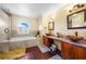 Luxurious bathroom featuring a soaking tub, dual vanities, and modern fixtures at 1233 Nelson Park Court, Poinciana, FL 34759