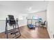Bright bonus room featuring an inversion table, treadmill, office setup and ceiling fan at 1233 Nelson Park Court, Poinciana, FL 34759