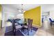 Open dining area with stylish light fixture, connecting to the living spaces at 1233 Nelson Park Court, Poinciana, FL 34759