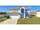 Charming two-story home with a two-car garage, arched entryway, and well-maintained lawn at 1233 Nelson Park Court, Poinciana, FL 34759
