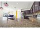 Eat-in kitchen features granite countertops, stainless steel appliances, and tile backsplash at 1233 Nelson Park Court, Poinciana, FL 34759