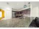 Spacious kitchen featuring granite counters, stainless steel appliances, and a breakfast bar at 1233 Nelson Park Court, Poinciana, FL 34759