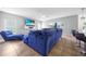 Comfortable living room with a plush blue sectional sofa and entertainment center at 1233 Nelson Park Court, Poinciana, FL 34759